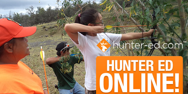 Outdoor scene showing a female instructor teaching a teenage girl how to aim a bow.